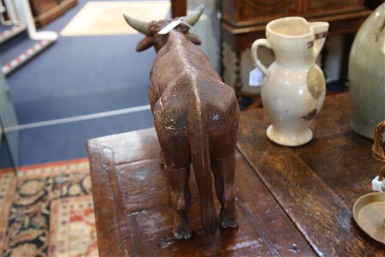An 18th / 19th century carved and painted figure of a bullock, possibly from a Créche group, L.14.75in.
